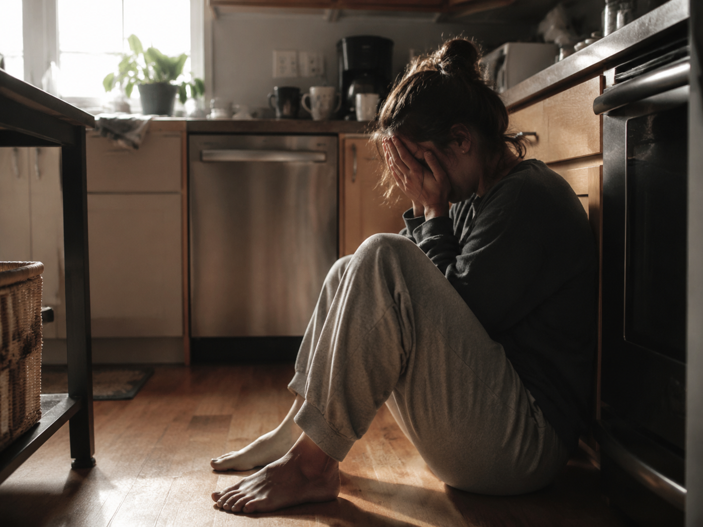 Woman with hands covering face in frustration